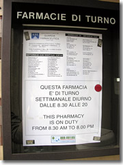 A sign outside each pharmacy in Iyaly lists the schedule for which drug stores in town are open 24 hours and on Sundays a holidays.