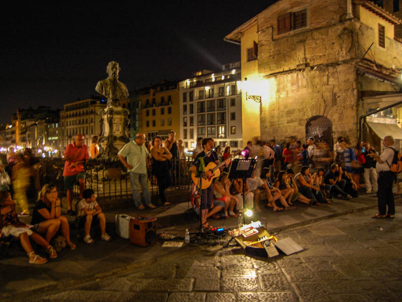 A busker entertains the evening crowds on the tiny piazetta in the middle of the Ponte Vecchio, Florence. (Photo by Joseph Maestri)
